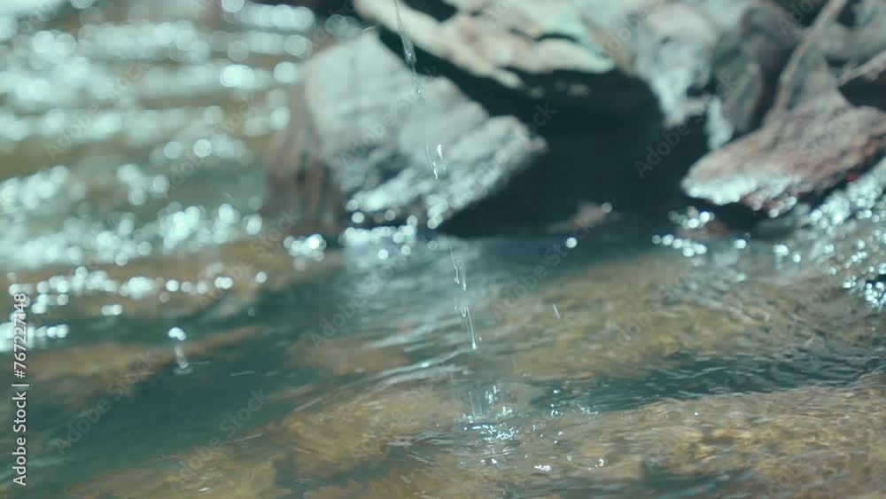 Close up portrait of a young woman cupping hands catching water from river in the mountain Close up portrait of a young woman cupping hands catching water from river in the mountain