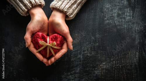 Person Holding Heart Shaped Box With a Bow