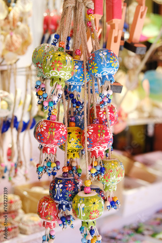 Colorful Turkish Ceramic Bells on Display. A display of colorful Turkish ceramic bell ornaments adorned with evil eye beads at a local market.