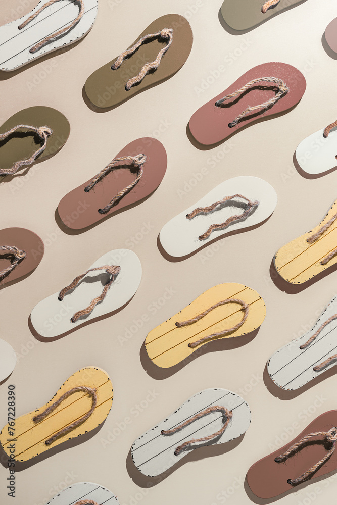 Female summer shoes, sandals as creative minimal pattern with hard shadow, beige brown white flip flops on beige gradient color background. Aesthetic trend summer fashion concept, life style photo Female summer shoes, sandals as creative minimal pattern with hard shadow, beige brown white flip flops on beige gradient color background. Aesthetic trend summer fashion concept, life style photo