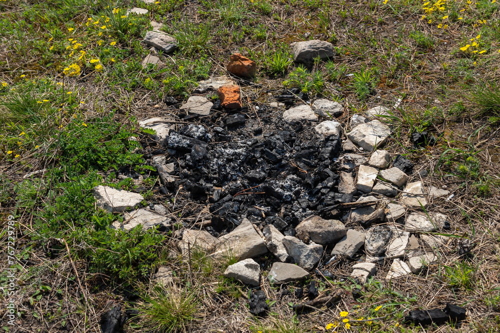 Abandoned extinct stone hearth for bonfire. Survival in wild. Protecting forest from spread of fire Abandoned extinct stone hearth for bonfire. Survival in wild. Protecting forest from spread of fire