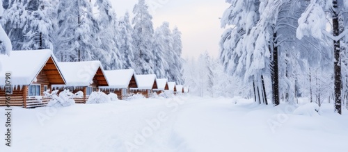 Snowy path between two cabins in forest © Ilgun