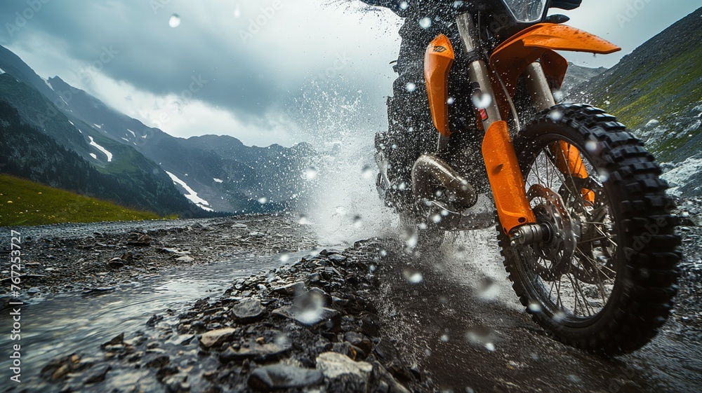 Rider navigating a wet rocky path on a bike - obrazy, fototapety, plakaty 