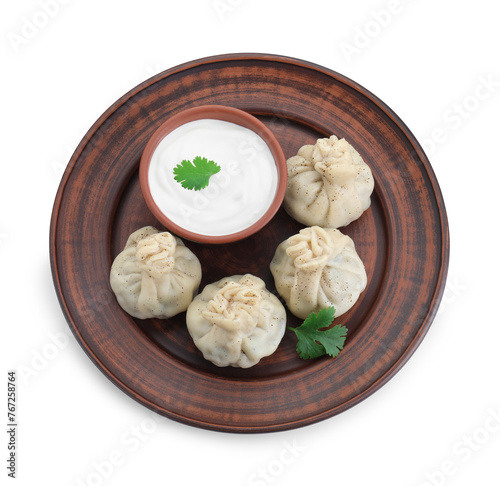 Tasty khinkali (dumplings) with sauce and spices isolated on white, top view. Georgian cuisine