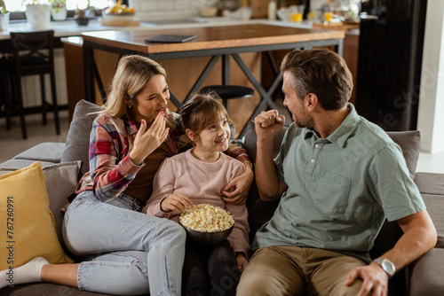 Cozy family time: sharing laughter and popcorn on a casual evening