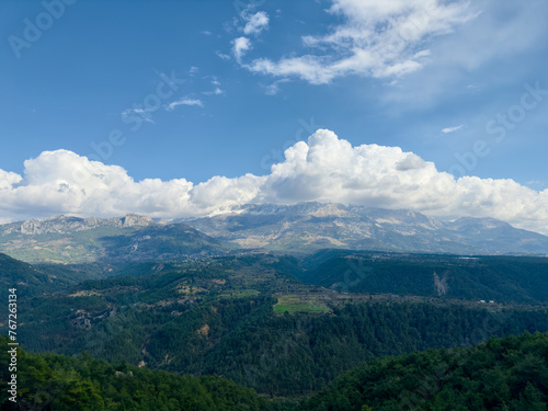 Expansive view featuring the mountain ranges near Köprülü Canyon in Antalya, under a sky with dramatic clouds. © gokcen