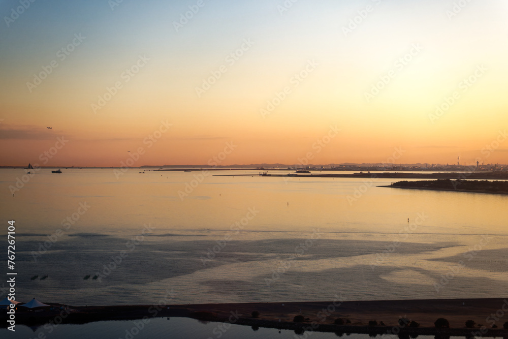 Aerial view of beautiful sunset with bay of water at City of Tokyo on a sunny winter day. Photo taken January 29th, 2024, Tokyo, Japan.