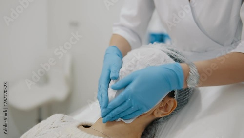 Cleaning a girl's face with napkins before beauty injections
