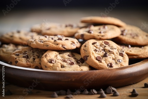 Tempting chocolate chip cookies on a rustic plate against a white background