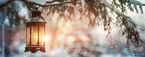 A vintage lantern hanging from a snowy tree branch, snow falling gently around it, with a softly blurred background photo