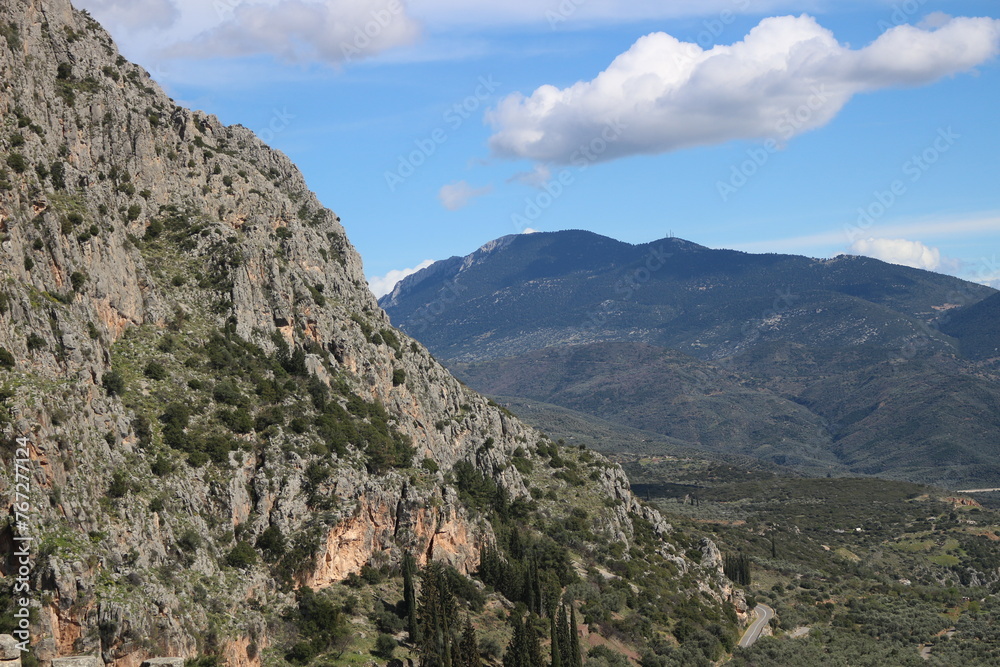 Majestic Embrace: Delphi Enveloped by Mountain Majesty