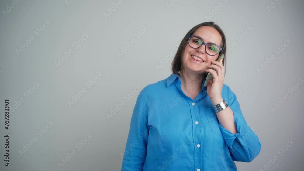 Happy business woman talking in phone call, mobile conversation or communication with a cellphone. Happy, smile and female with style isolated in a studio grey background on a smartphone Happy business woman talking in phone call, mobile conversation or communication with a cellphone. Happy, smile and female with style isolated in a studio grey background on a smartphone