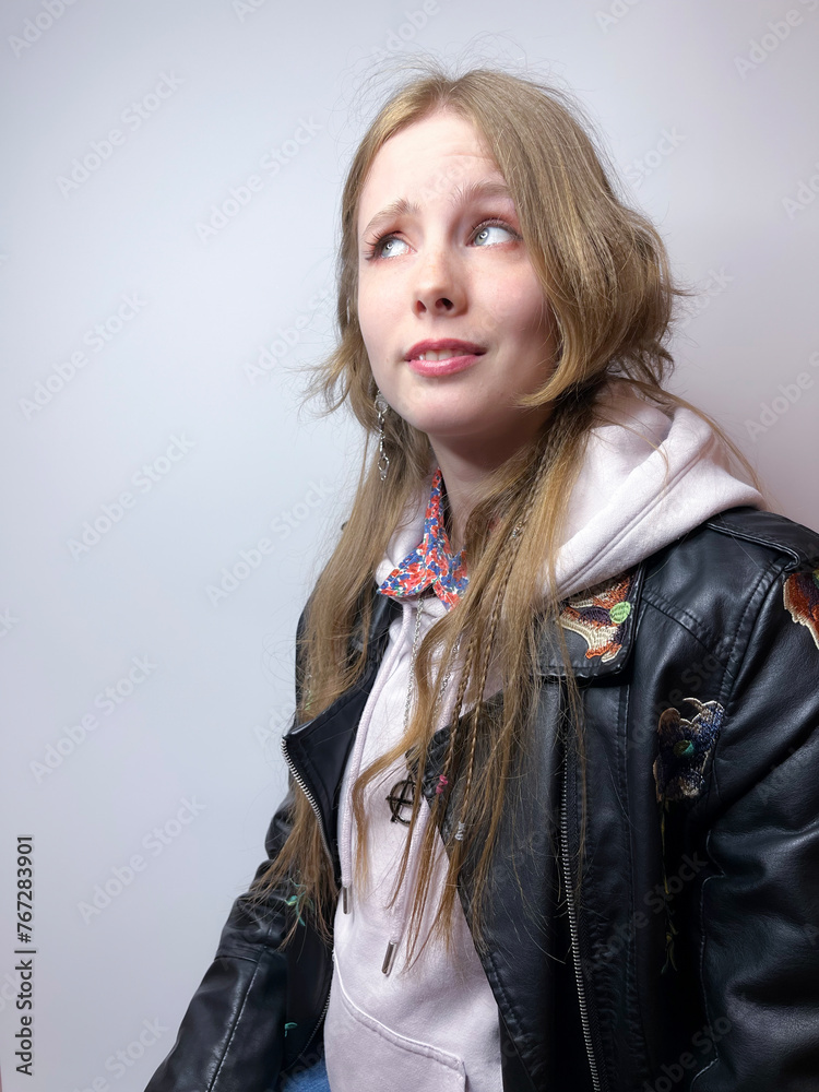 a young girl in a black leather jacket a young girl in a black leather jacket