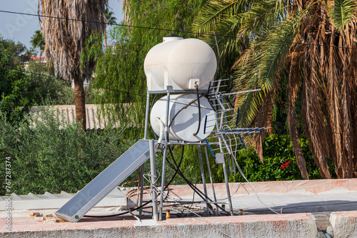 Water heating boiler. Solar collector, boiler for heating water on the roof of the building © Armands photography