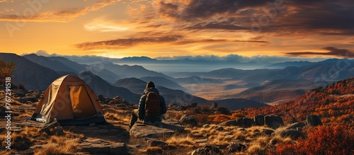 Tourist camping in the mountains at sunset. Beautiful autumn landscape.