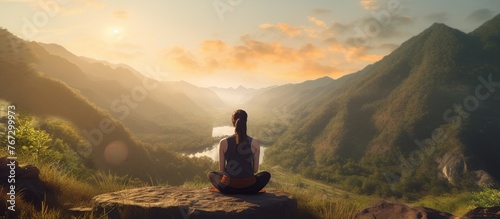 Woman meditating yoga alone at sunrise mountains. photo