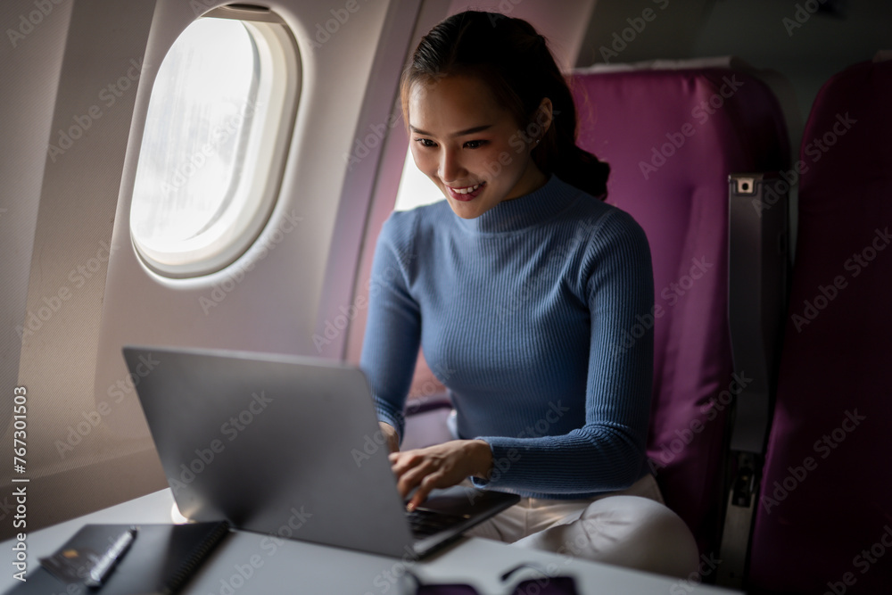Woman Working on Laptop During Flight Woman Working on Laptop During Flight