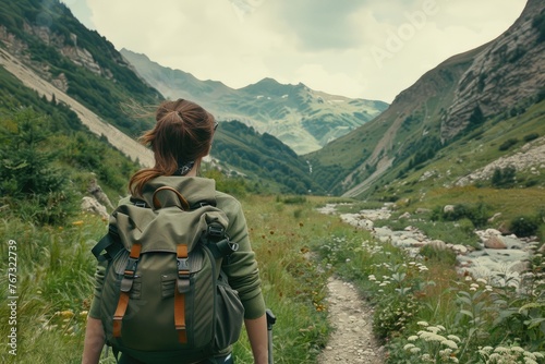 woman with backpack going hiking through mountains