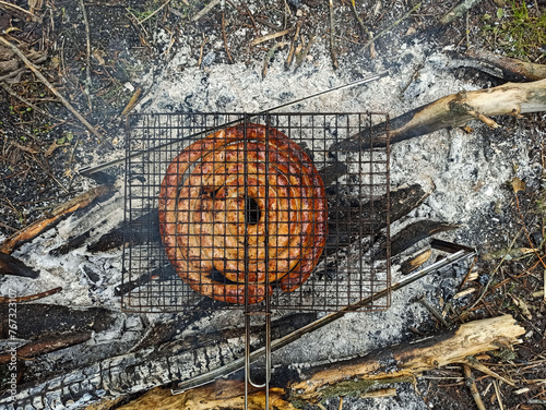 Homemade sausage grilled over a fire at a picnic