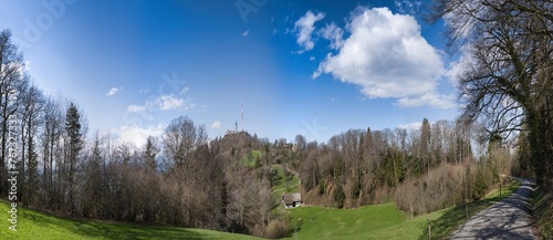 Large panorama of the kulm Uetliberg under a blue sky with white clouds