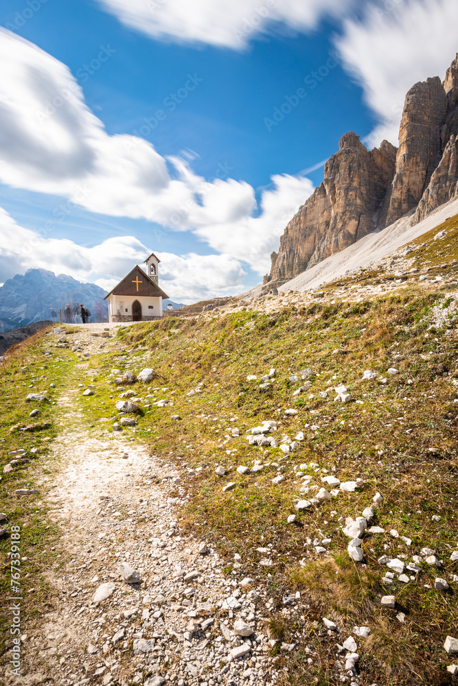 Rocky footpaths  leading to a small chapel below the peak of Tre Cime in Dolomites Italy