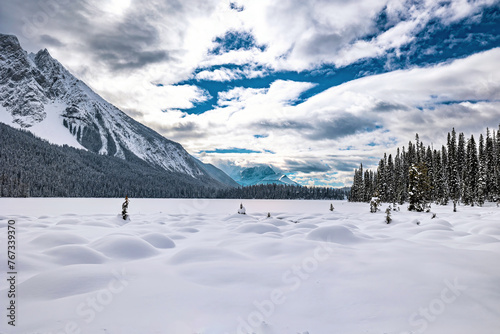Snow on Rocky Mountain Trails during Winter around a frozen lake
