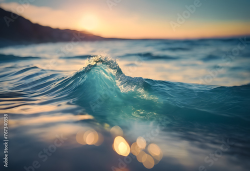Close-up of a small wave cresting with sunset light in the background, creating a tranquil ocean scene.