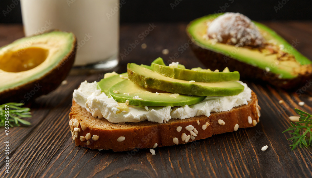 Toasted bread with with cream cheese and avocado on table. Delicious and healthy sandwich. Toasted bread with with cream cheese and avocado on table. Delicious and healthy sandwich.