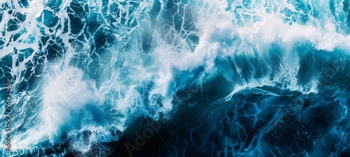 Ocean waves crashing against the shore as seen from above, showcasing the power and movement of the water photo