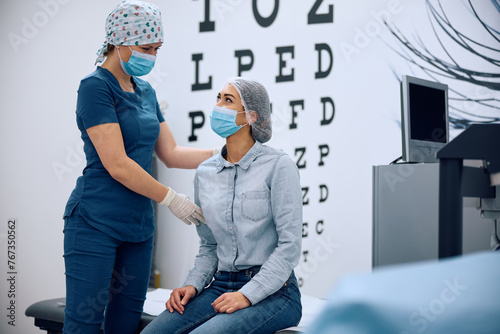 Happy woman and ophthalmologist during medical procedure at eye clinic. photo