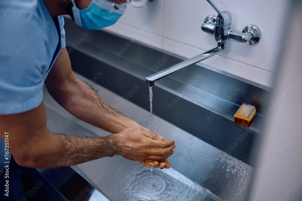 Close up of surgeon washing hands before getting into operating room.