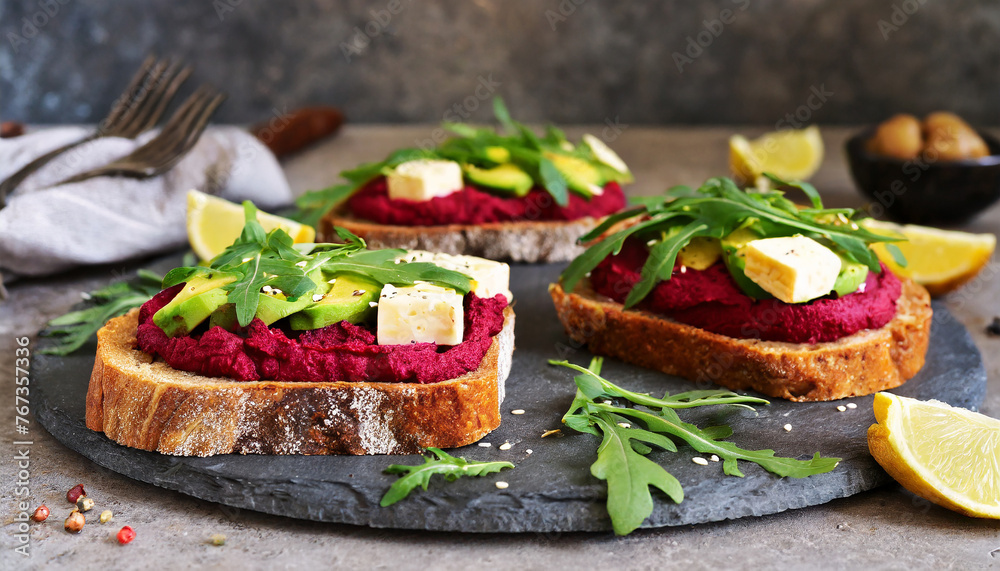 Vegan hummus beet sandwich. Sandwich with beet, cheese, avocado and arugula. Tasty and healthy food. Vegan hummus beet sandwich. Sandwich with beet, cheese, avocado and arugula. Tasty and healthy food.