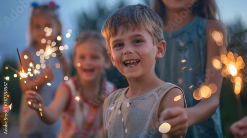 A group of children playing with sparklers during a 4th of July evening celebration.