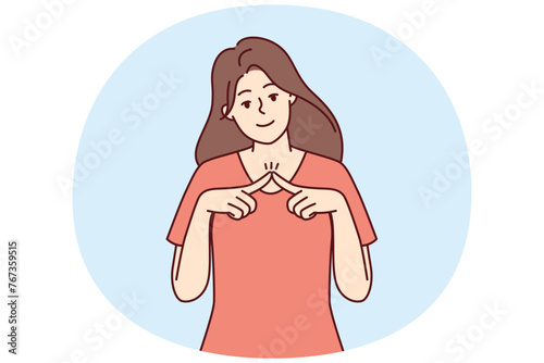 Shy girl looks at camera and joins fingers in front of chest, wanting to seduce guy. Modest young woman dressed in casual t-shirt shyly tries to flirt and attract attention of interlocutor