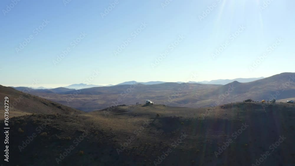 Aerial Shot Of People With Off-Road Vehicle On Semi Arid Mountain During Vacation, Drone Flying Backwards During Sunny Day - La Serena, Chile Aerial Shot Of People With Off-Road Vehicle On Semi Arid Mountain During Vacation, Drone Flying Backwards During Sunny Day - La Serena, Chile