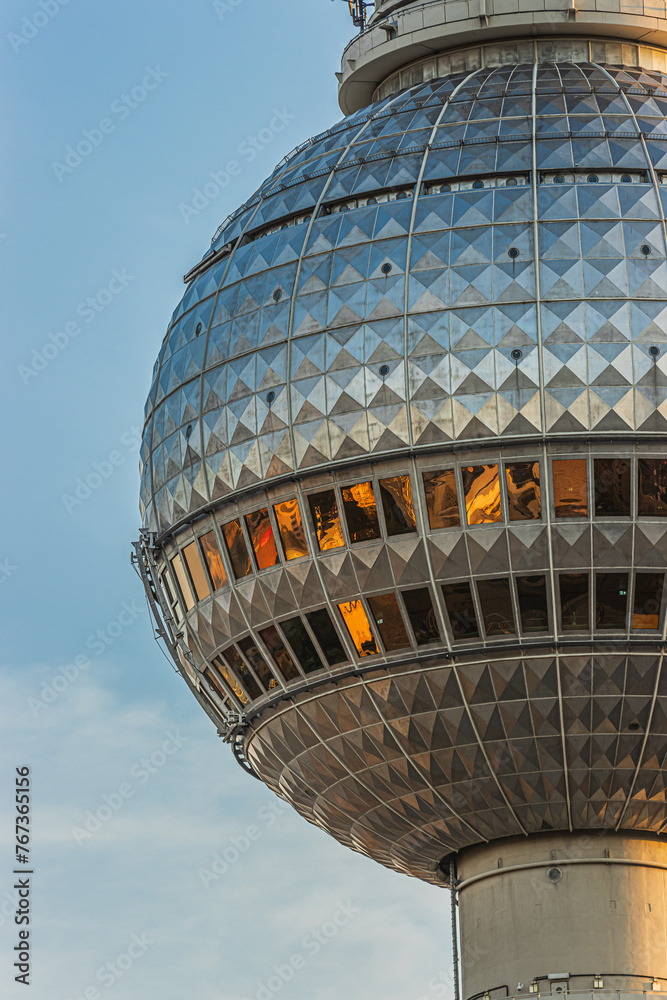 Partial detail of the sphere of the Berlin television tower in the evening sun. left side of the sphere of the landmark in the capital of Germany. Details of the two rows of mirrored windows Partial detail of the sphere of the Berlin television tower in the evening sun. left side of the sphere of the landmark in the capital of Germany. Details of the two rows of mirrored windows