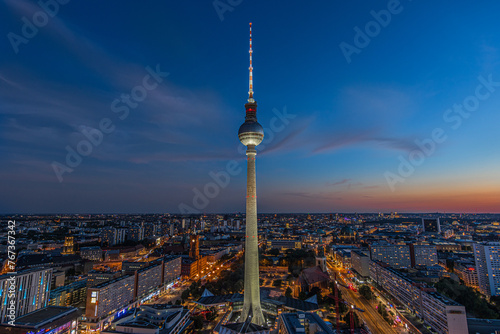 Evening mood of the Berlin skyline at the blue hour. Illuminated television tower at Alexanderplatz in the center of the capital of Germany. Illuminated buildings and streets with the Red Town Hall
