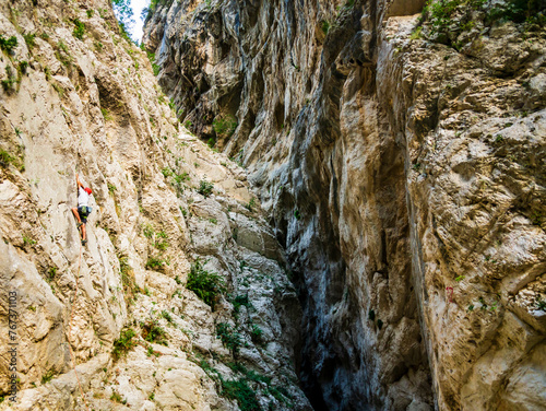 Man is experiencing and exciting vertical climb in the beautiful scenery of fara san martino gorges, Majella National Park, Abruzzo, Italy
