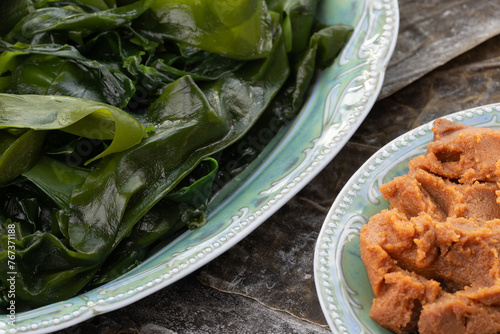 Red miso paste, rehydrated wakame seaweed and dried kelp. Main ingredients for many asian dishes and soups. photo