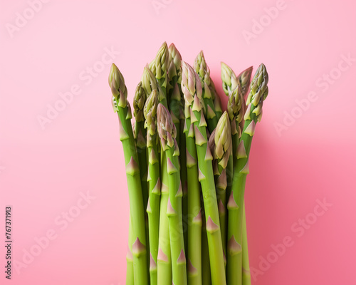 Fresh Asparagus Spears Lined Up on Pastel Pink Background