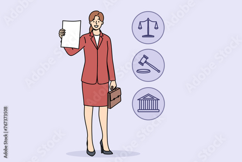 Woman lawyer demonstrates court decision on absence of claims against client, standing near legal symbols. Girl corporate lawyer with smile shows contract or permission received from ministry justice