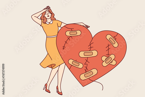Woman cries after breaking up with man and having problematic relationship, standing near large wounded heart. Upset girl is stressed because of unrequited love or tactical relationship with husband © drawlab19