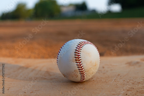Baseball Sitting on Home Base in the Baseball Infield