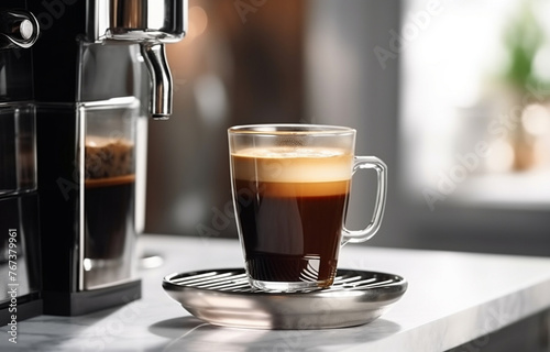 black coffee is poured into a glass cup that stands on a metal s