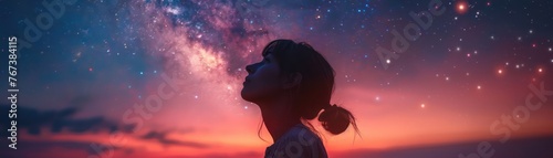  Double exposure of a woman looking up merged with a summer night sky lit by the Milky Way