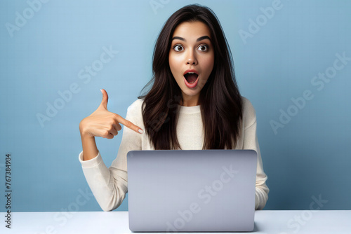 Surprised woman looking at laptop.