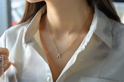 
gold initial A necklace pendant of  A on women neck photo