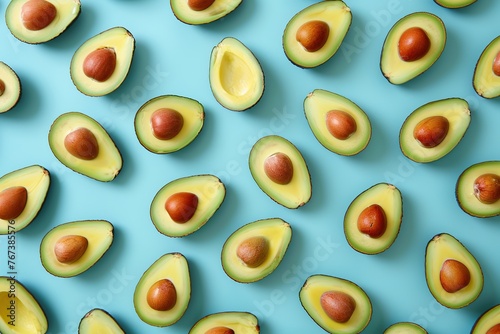 Pattern of fresh avocado pieces on blue background