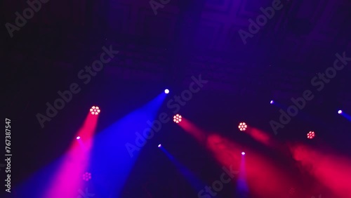 a colorful light show and a huge number of multicolored laser beams in a large indoor space