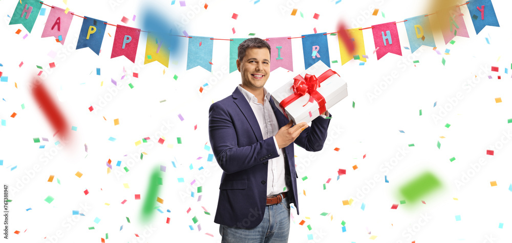 Young man celebrating birthday and holding a present Young man celebrating birthday and holding a present